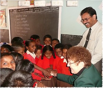 Rotary District 7150 Governor Marlene Brown greeting students at the Rotary school in Ooty sponsored by the RC of Ootacamund, India, accompanied by Rtn. Dr. Baju